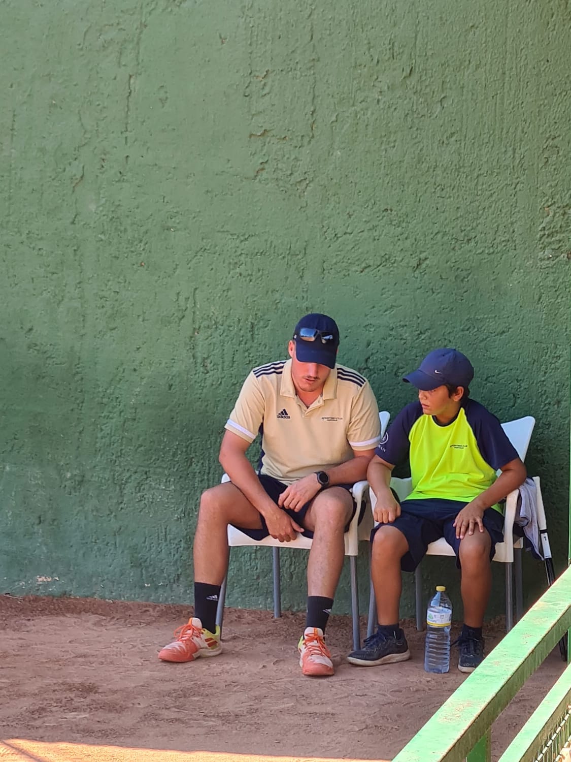 Pepe Demi charlando con un joven tenista en pista de tierra batida